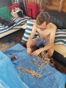 Sébastien ouvre des causses de chou pour en extraire les graines.